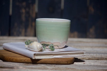 Lime green and orange ceramic cup
