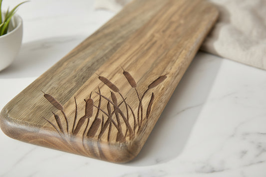 Wooden cutting board with grass design on a white surface